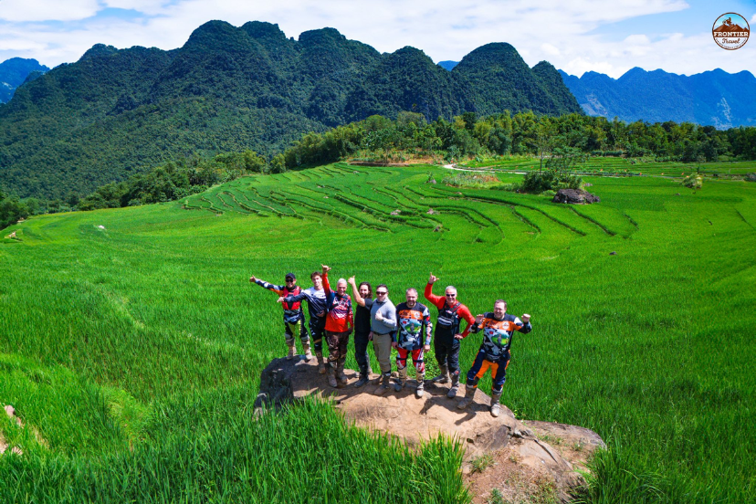 Visitor walking along scenic terraced rice fields in Mu Cang Chai.